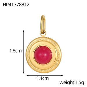 Macro shot of 1.6x1.4cm gold-plated round pendant with red gemstone and beaded texture