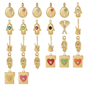 Collection of golden Hamsa hand, Om symbol, and guitar pendants with colorful rhinestones