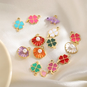 Colorful enamel leaf and shell charms on satin for DIY jewelry bracelets and necklaces