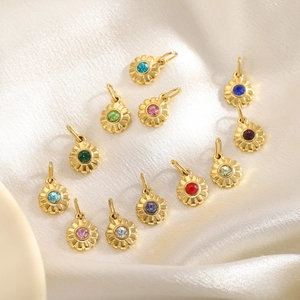 Pendentifs fleur avec oxydes de zirconium multicolores posés sur du satin blanc soyeux