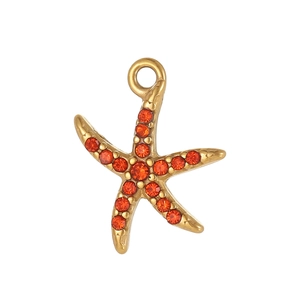 Macro shot of gold-finished starfish charm featuring vibrant orange micro-pavé crystals