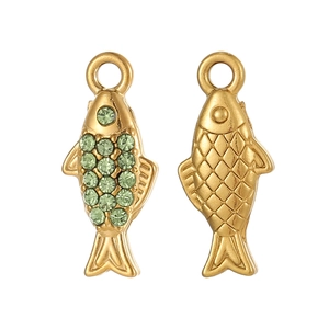 Macro detail of fish-shaped gold pendant with green cubic zirconia and fish scale texture