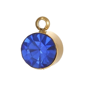 Macro detail of round blue faceted zircon pendant with gold metal setting for DIY jewelry
