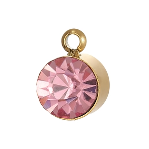 Macro shot of pink cubic zirconia pendant with gold plated setting and hanging loop