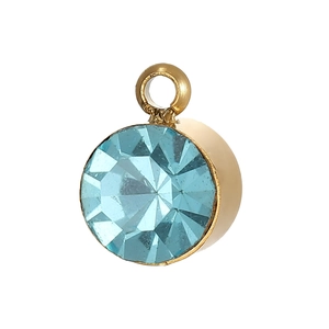 Macro detail of round light blue zircon pendant in gold setting for DIY jewelry
