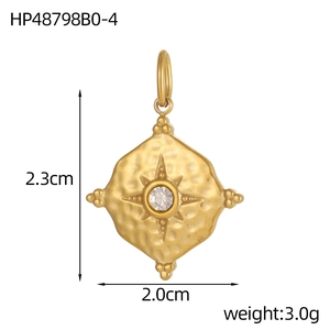 Close-up of a gold oval pendant with hammered texture and a sparkling birthstone