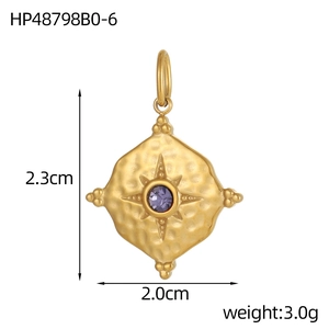 Detail of gold hammered diamond pendant with purple birthstone and star engraving