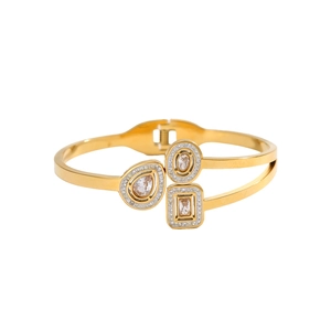Detailed view of the gold-plated spring bracelet with three crystal geometric charms