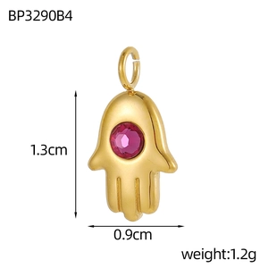 Detailed view of Hamsa Hand pendant in gold stainless steel with red zircon inlay