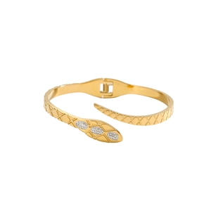 Luxury gold snake-shaped stainless steel bracelet with textured scales and crystals