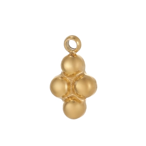 Macro shot of a vintage gold-plated cross pendant with four spheres for DIY jewelry making