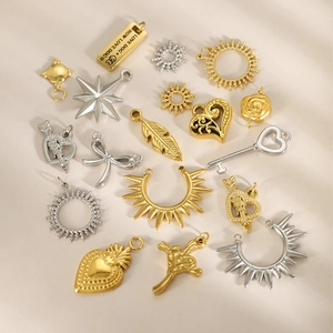 Assorted gold and silver stainless steel charms including sun, heart, and cross for DIY jewelry
