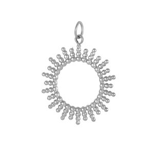 Macro detail of silver sunburst pendant featuring beaded texture and radial design
