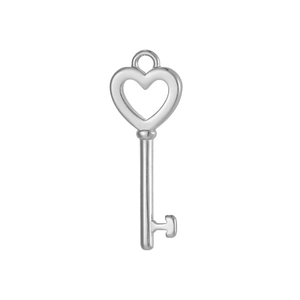 Polished silver heart-shaped key pendant detail showing hollow design and metal teeth