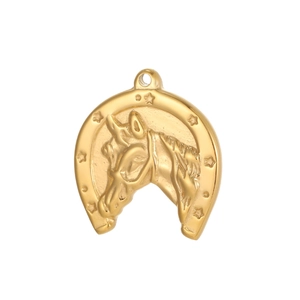 Macro shot of horseshoe pendant with horse head relief and stars in golden finish