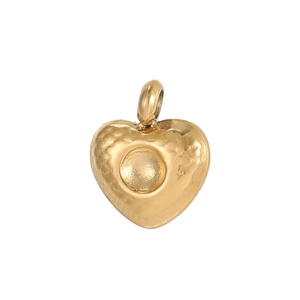 Detailed view of heart-shaped gold pendant with vintage hammered texture and metal loop