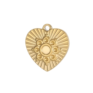 Macro detail of French gold heart pendant with radial texture and circular center