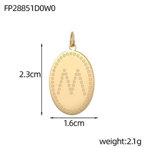 Detailed view of an oval gold-plated pendant with dotted M letter and size dimensions