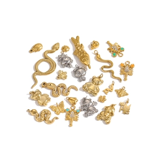 Flat lay of gold and silver animal pendants including butterfly, bee and bear for DIY jewelry