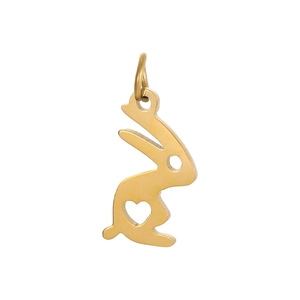 Macro shot of a golden bunny-shaped pendant with a heart-shaped hollow detail