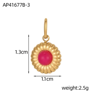 Macro shot showing dimensions of 1.3cm by 1.1cm for the red stone sunburst pendant