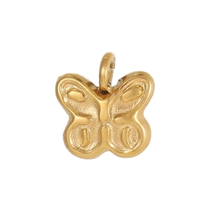 Close-up of golden butterfly pendant charm with detailed embossed metal texture