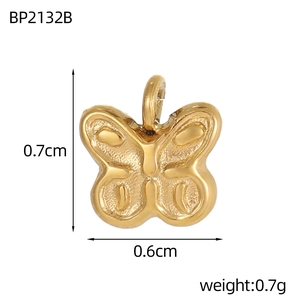 Golden butterfly pendant with detailed relief lines showing 0.7cm height and 0.6cm width