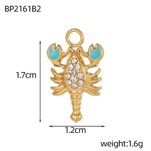 Golden lobster pendant with white rhinestones and blue enamel details showing 1.7cm size