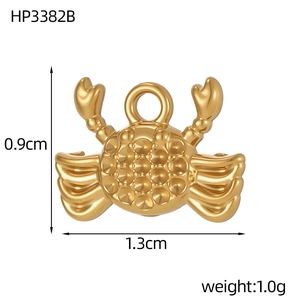 Detail of a 1.3cm wide gold crab charm showing dimensions and polished metal texture