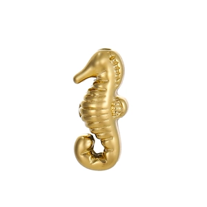 Detailed macro view of a golden seahorse charm made from polished stainless steel