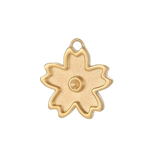 Detailed view of a gold-plated cherry blossom charm with matte and polished finishes
