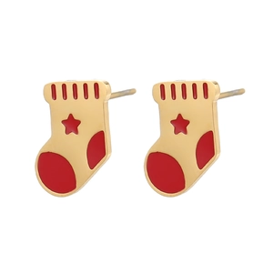 Close-up of cute Christmas stocking stud earrings with red enamel and gold accents