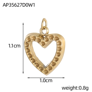 Macro detail of gold heart pendant with beaded edges showing dimensions 1.1cm by 1.0cm