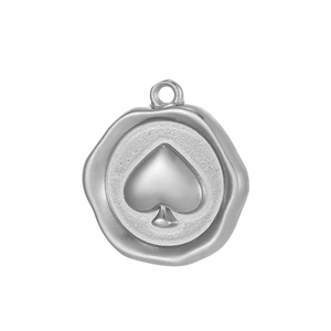 Macro view of a silver stainless steel spade seal pendant with vintage texture