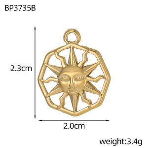 Detail view of 2.3cm gold sun face pendant with embossed 3D design and ray pattern