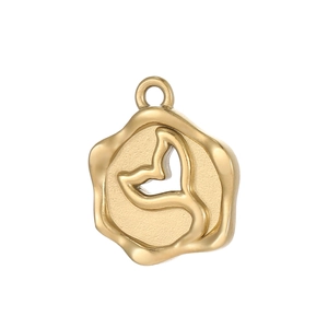 Macro detail of a golden irregular seal pendant featuring a cutout whale tail design