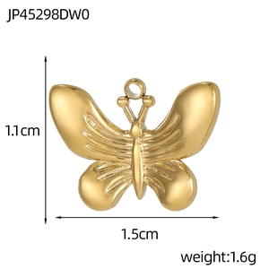 Detailed view of a gold butterfly pendant with wings texture, height 1.1cm and width 1.5cm