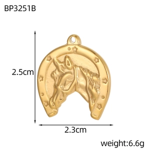 Detailed view of a golden horseshoe pendant with horse head and size measurements