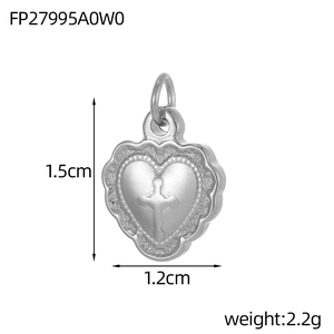 Detailed macro view of heart-shaped stainless steel pendant with cross relief and wave edge