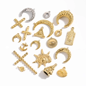 Collection of gold vintage stainless steel charms with cross, moon, and celestial motifs