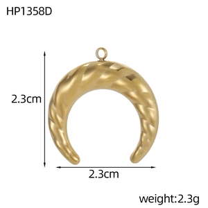 Macro detail of a 2.3cm gold crescent pendant with spiral texture and round buckle