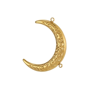 Macro detail of crescent moon charm with gold plating and floral filigree relief