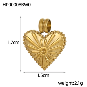 Detail of a golden heart pendant with sunburst texture, beaded edge, 1.7cm size