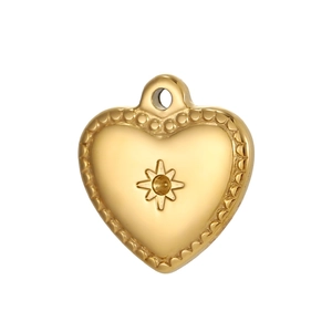 Detail of a golden heart pendant with a starburst pattern and polished finish