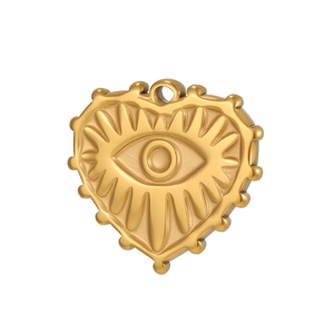 Macro side view of gold heart charm with evil eye relief and beaded edge detail