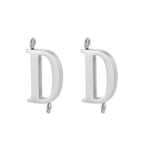 Close-up of polished stainless steel letter D pendant charms with double loops for DIY jewelry