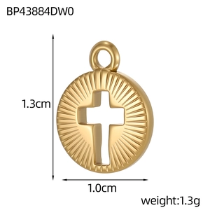Macro shot of 1.3cm gold stainless steel disc pendant with starburst texture and cross