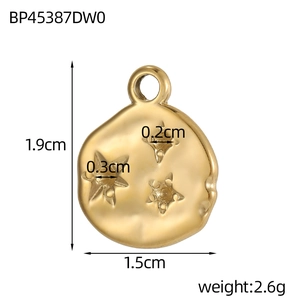 Detailed view of golden heart charm with hammered texture and 3D star-shaped motifs
