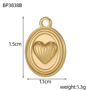 Detailed view of a gold heart pendant with dimensions 1.5cm by 1.1cm and textured surface