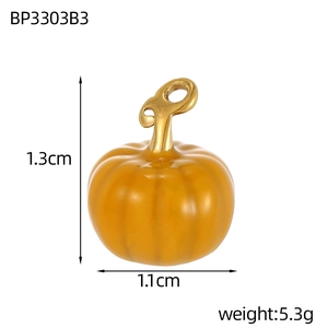 Macro detail of pumpkin shaped enamel charm with dimensions 1.3cm x 1.1cm for DIY jewelry